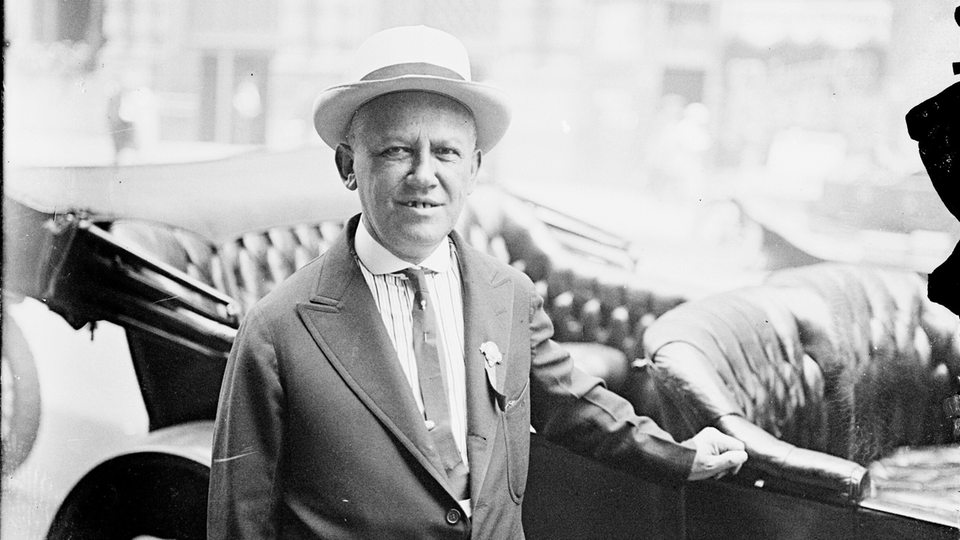 Carl Laemmle 1916 steht an einem Fahrzeug