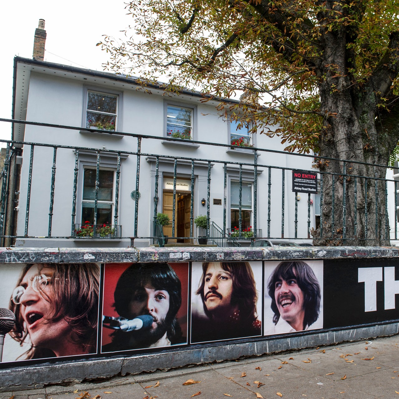 Die Abbey Road Studios haben am Zaun die Beatles Porträts angebracht
