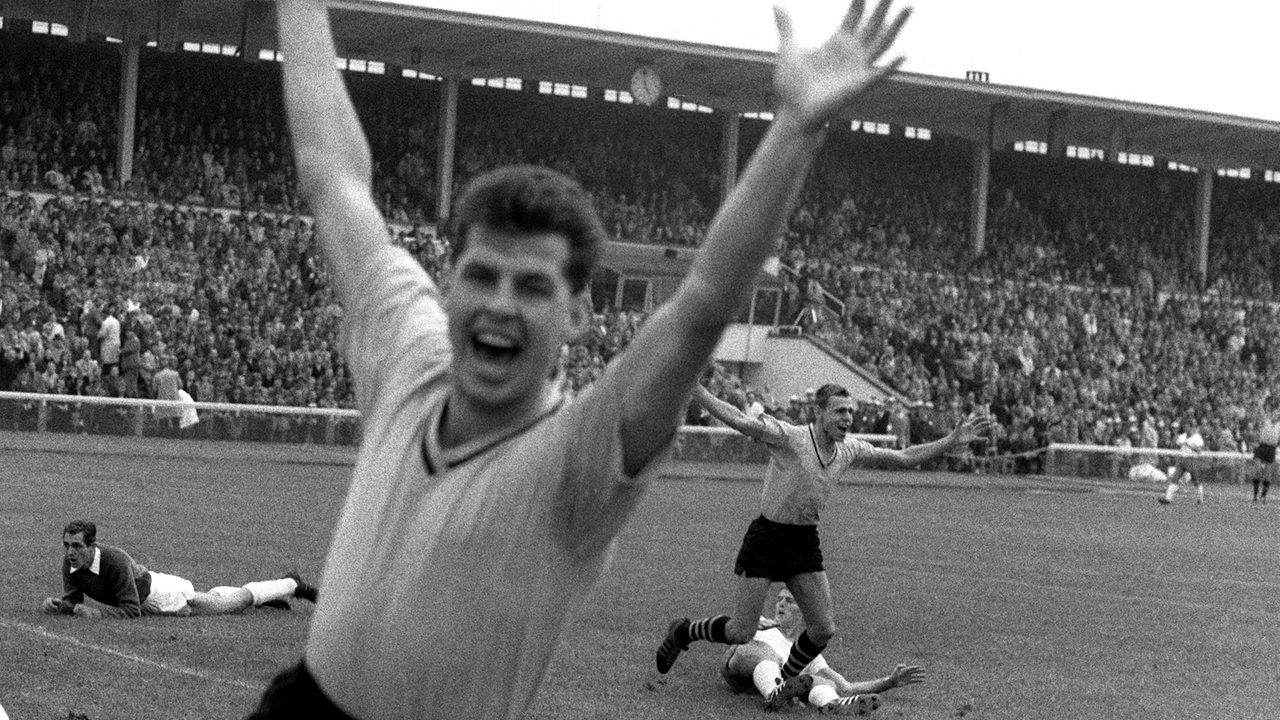 Der Dortmunder Torschütze Timo Konietzka (hinten, r) und sein Teamgefährte Lothar Emmerich (vorn) bejubelt das erste Tor beim Start der Fußball-Bundesliga am 24.08.1963 im Bremer Weserstadion.