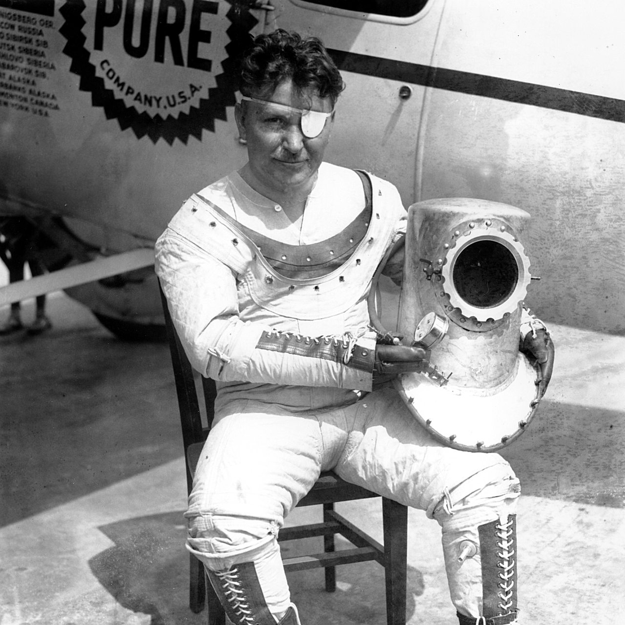Der einäugige Pilot Wiley Post in seinem Spezialanzug vor seinem Flugzeug "Winnie Mae"